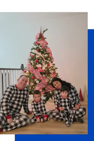 The Macaw Painting family: owners and their two children in a warm, family setting, representing our local family-owned business in Red Deer.